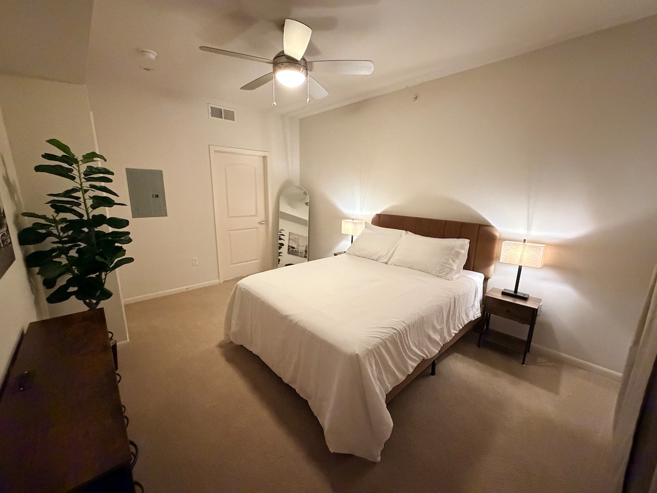 Bedroom with a queen bed and soft lighting