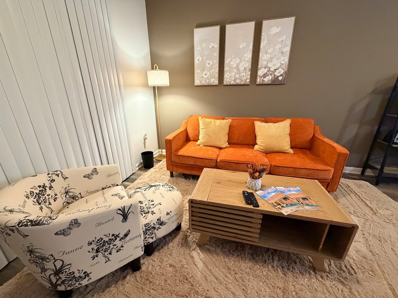 Bright living room with an orange sofa and balcony doors