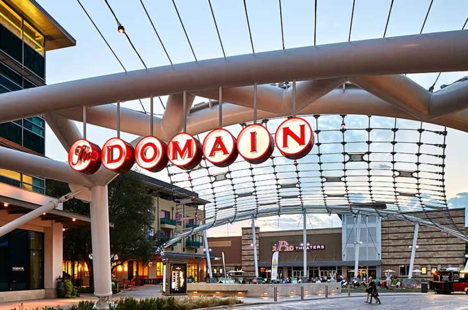 The Domain sign above a busy shopping street